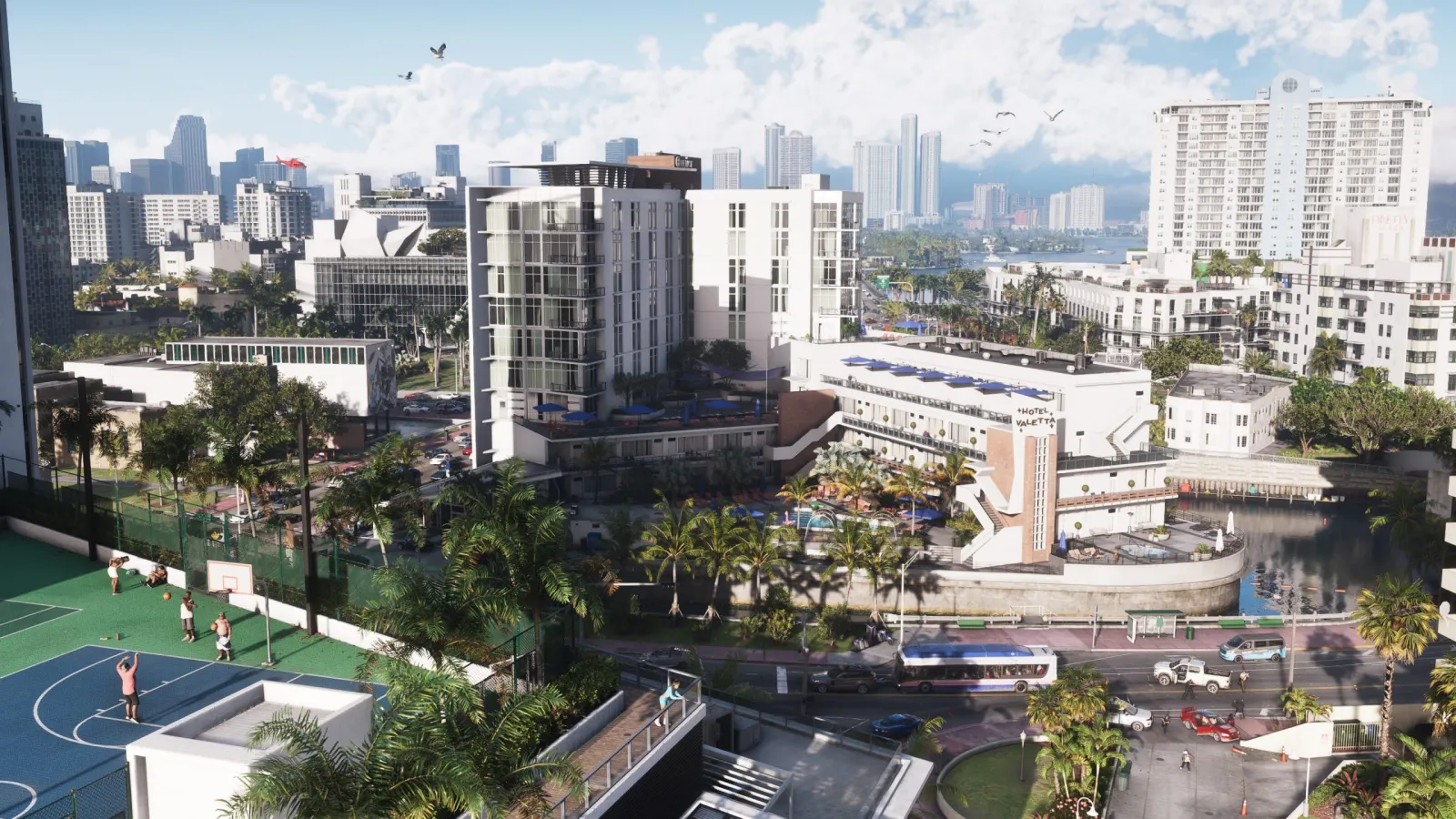 Daytime aerial of Vice City in GTA 6, showing dense blocks, a basketball court and the distant downtown skyline